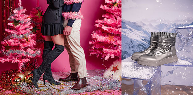 Pinker Weihnachtstraum mit sich umarmenden Pärchen – sie trägt Overknees. Winterstiefel vor Winterlandschaft.